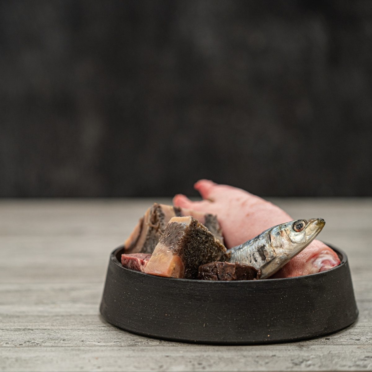 Assortment Of Ingredients Including, Pilchards, Tripe And Trotter In Metal Pet Bowl Assortment Of Ingredients Including, Pilchards, Tripe And Trotter In Metal Pet Bowl